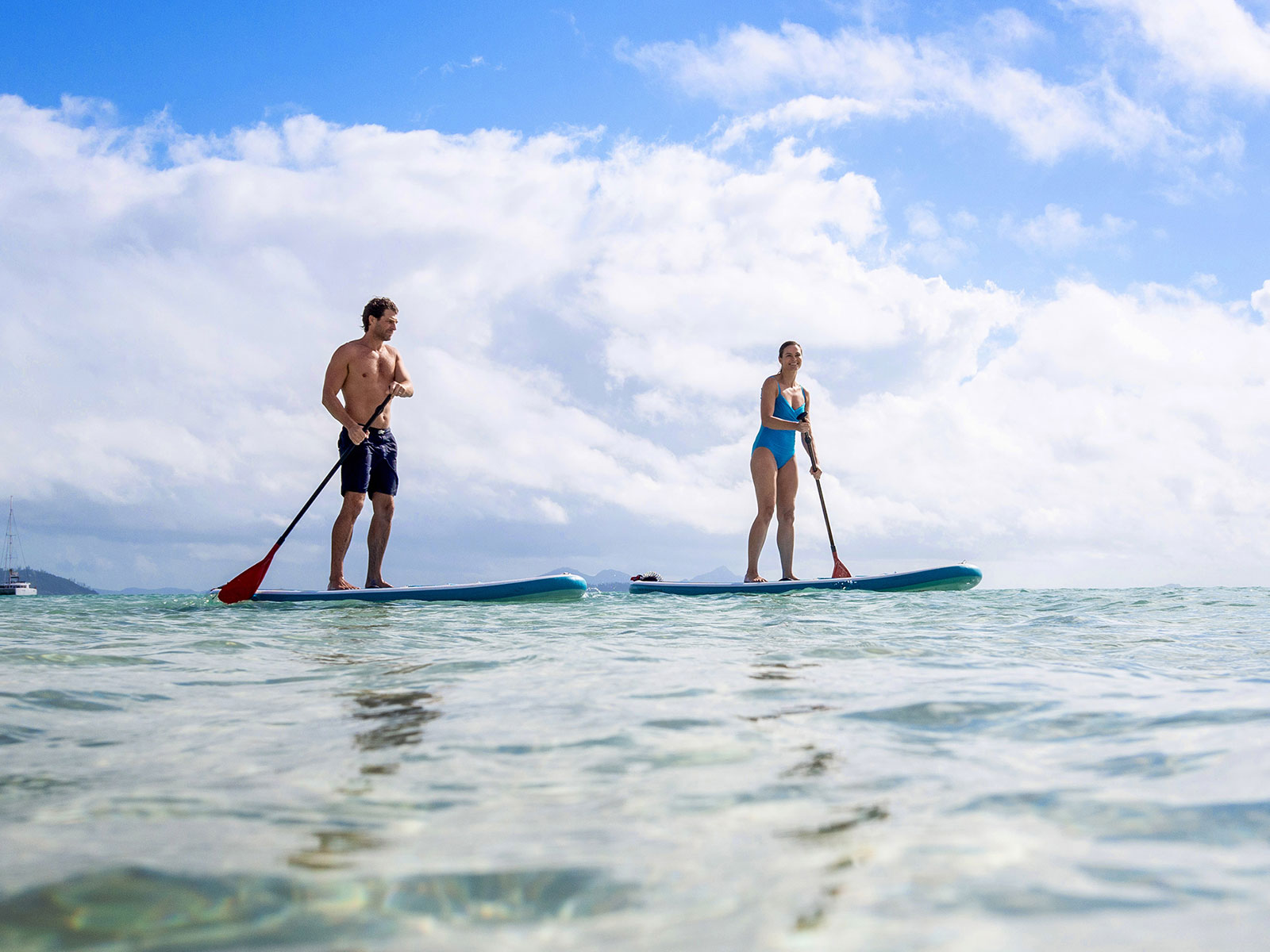 Man and women paddling boarding