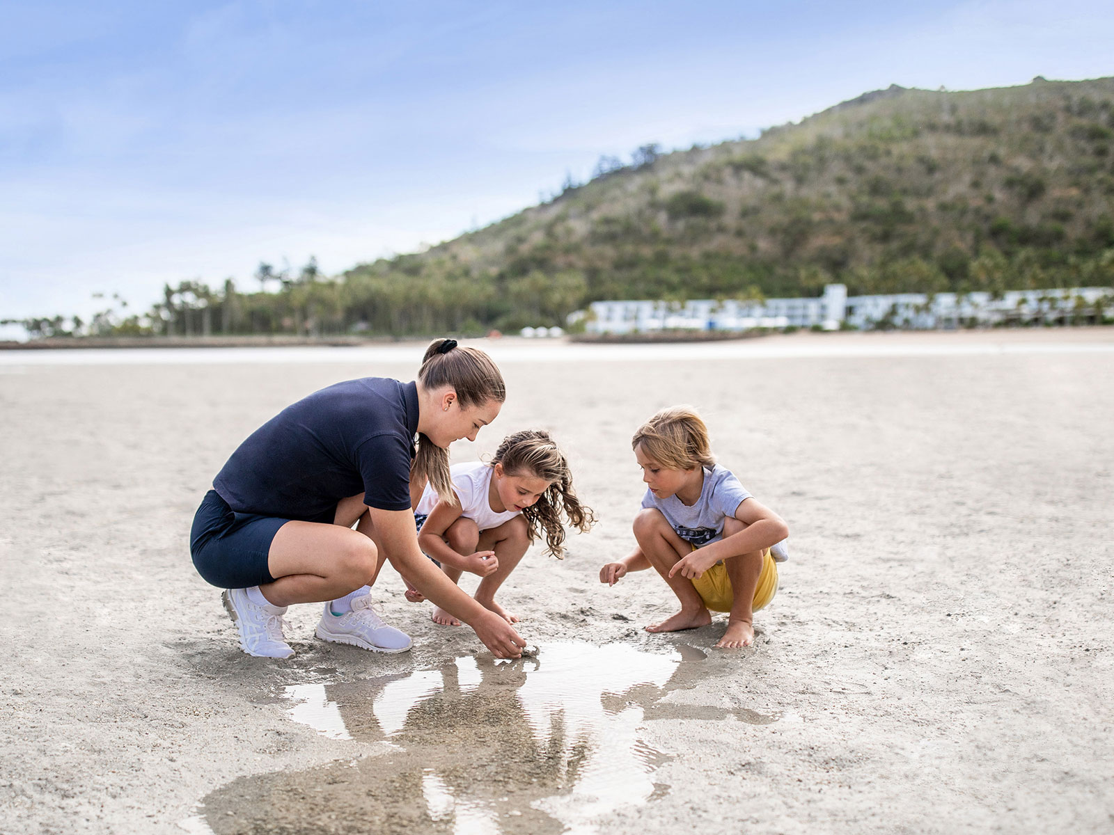 Lady and kids looking for shells